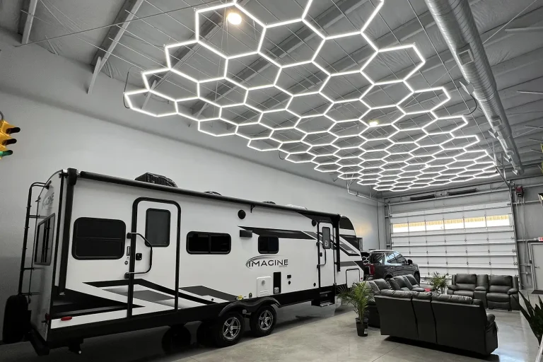 A large recreational camping vehicle parked in a high-end garage