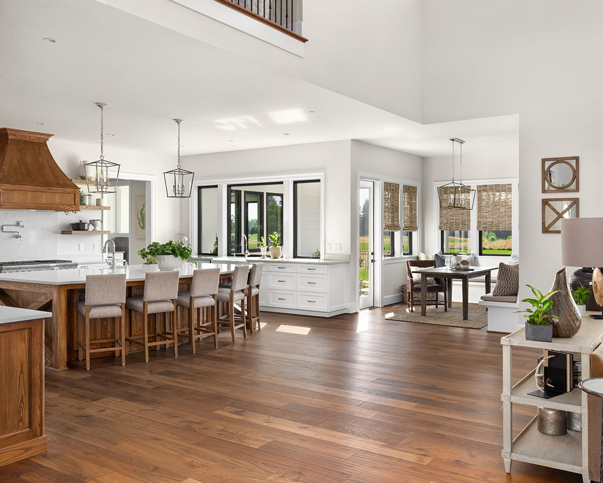 An open concept kitchen with medium oak flooring.